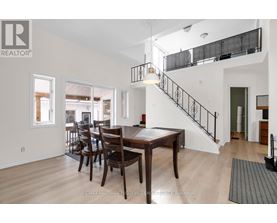 A dining room with a wooden table and chairs.