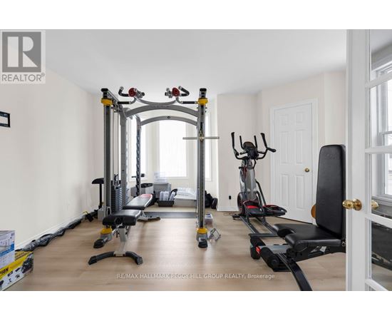 A spacious home gym with a variety of equipment including a treadmill, stationary bike, and weight machines.