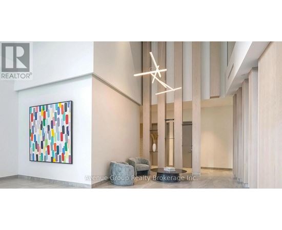 A large painting with many different colors is on the wall in a room.