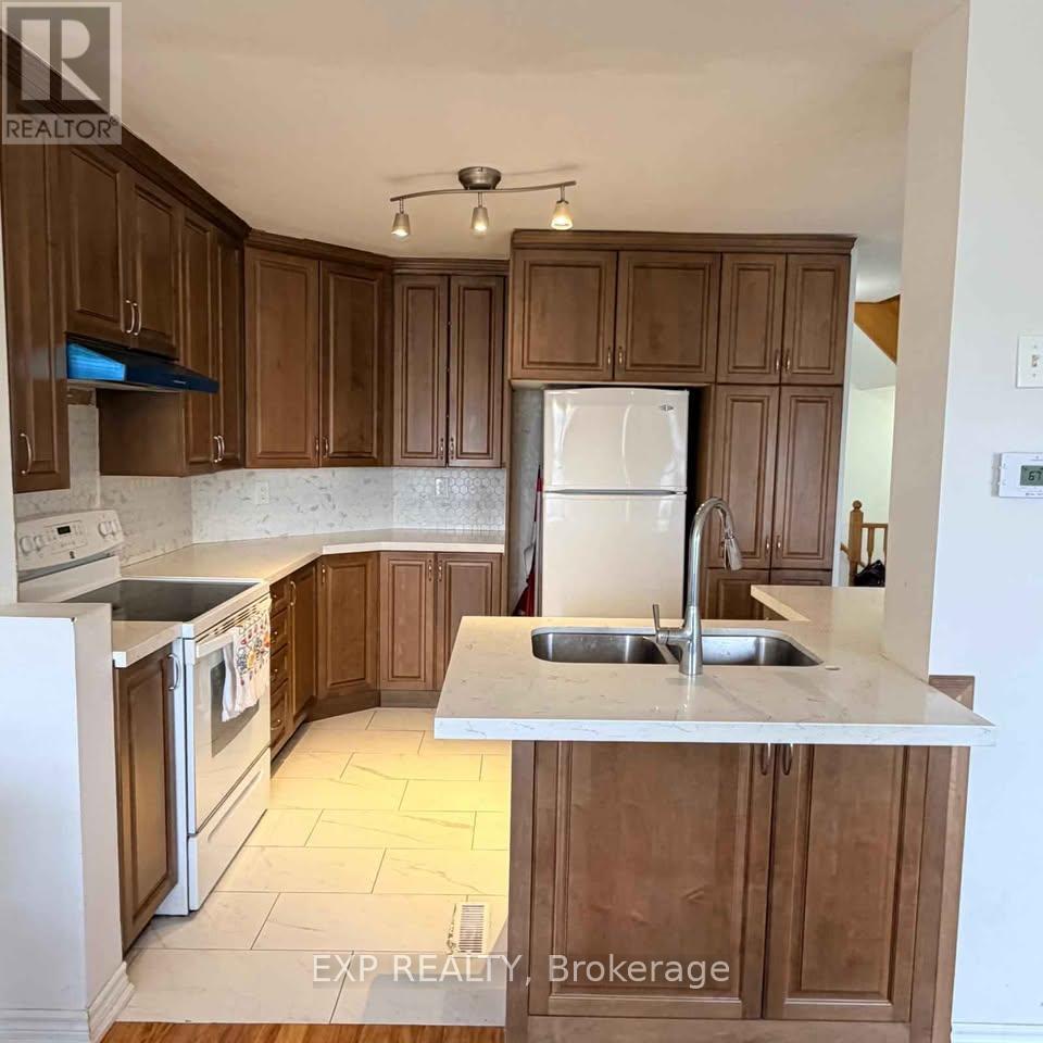 A kitchen with wooden cabinets and a white fridge.