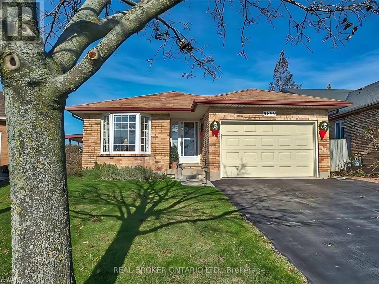 A house with a tree in front of it.