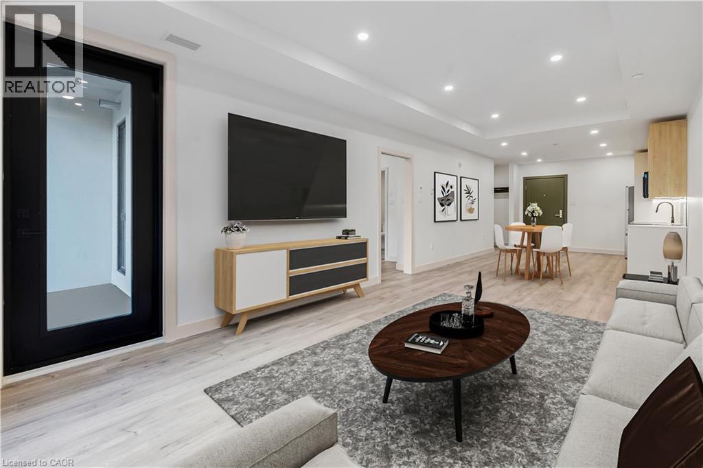 A modern living room with a flat screen TV mounted on the wall.