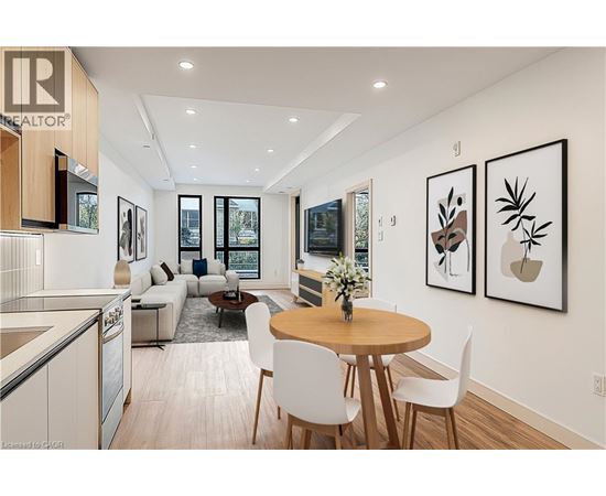 A modern open plan living and dining room with a kitchen area.