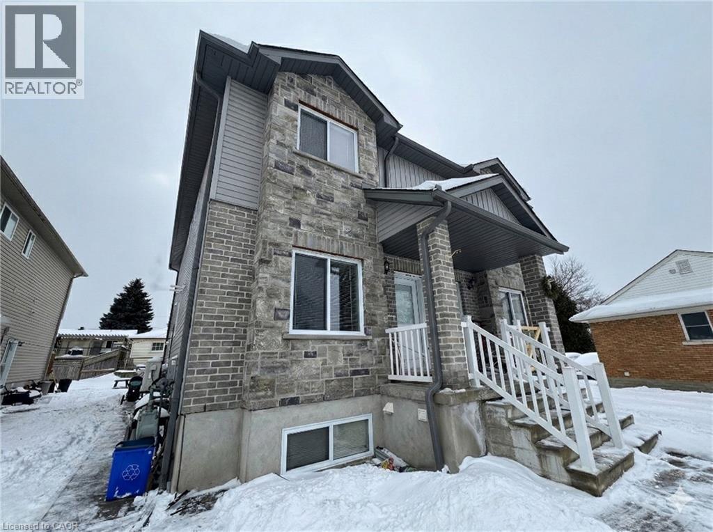 A house with a stone facade and a white porch.