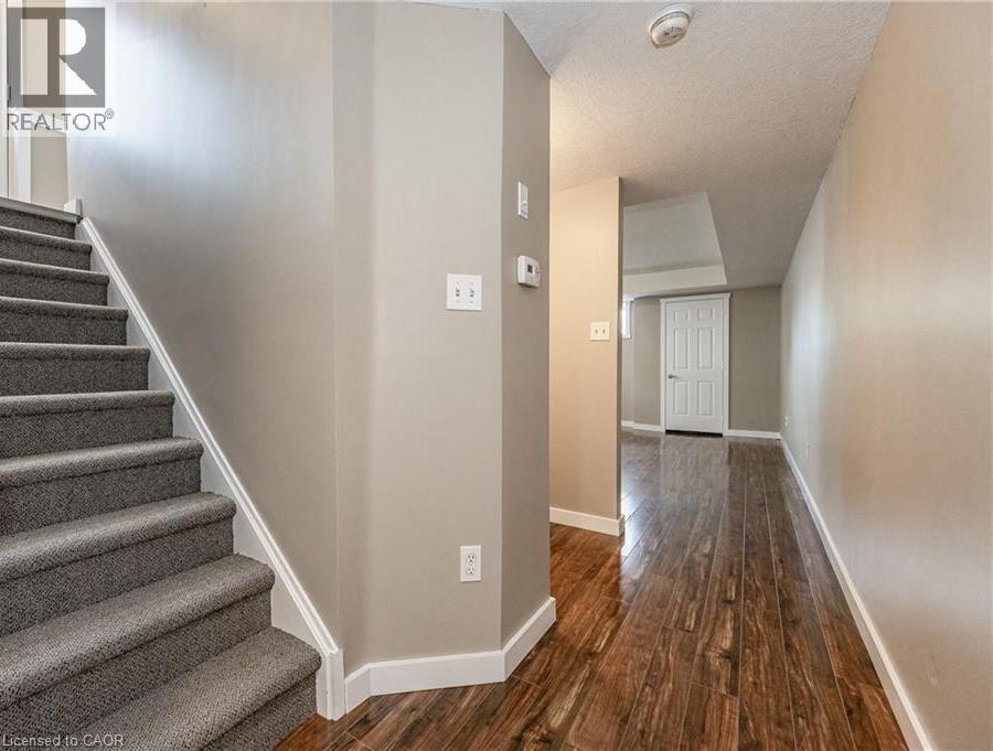 A hallway with a staircase leading to the second floor.