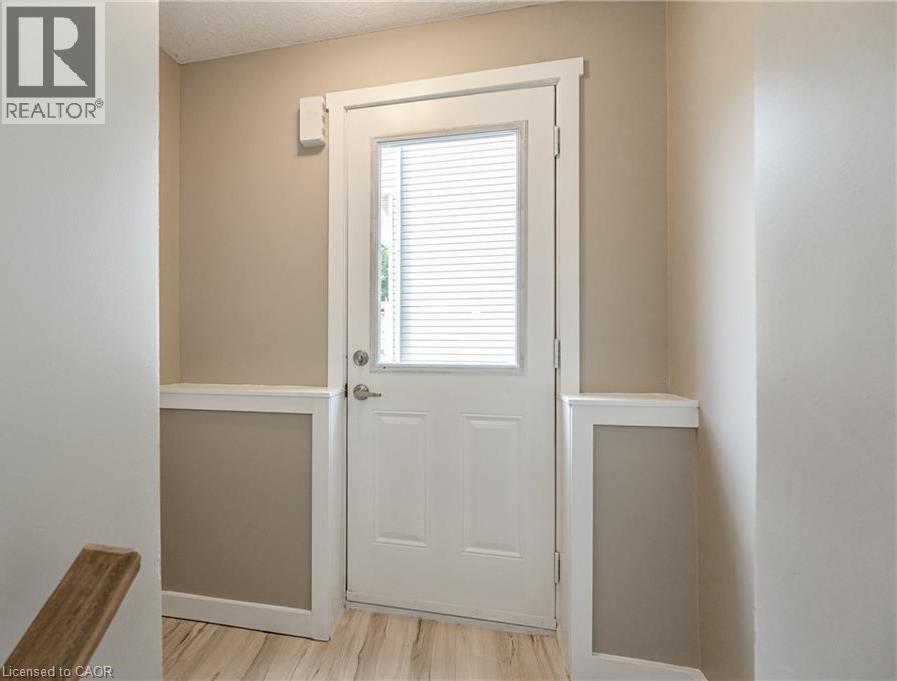 A white door with a window above it in a room.