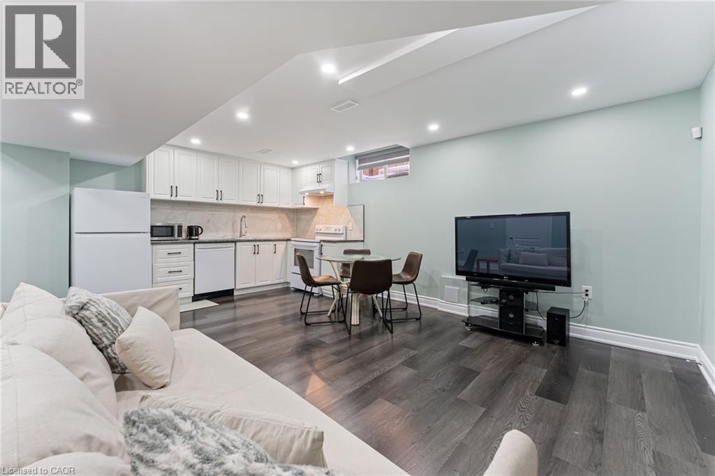 A modern living room with a white sofa and a television.