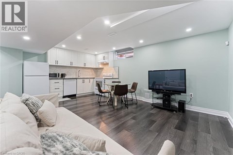 A modern living room with a white sofa and a television.