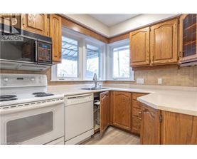 A kitchen with wooden cabinets and white appliances.