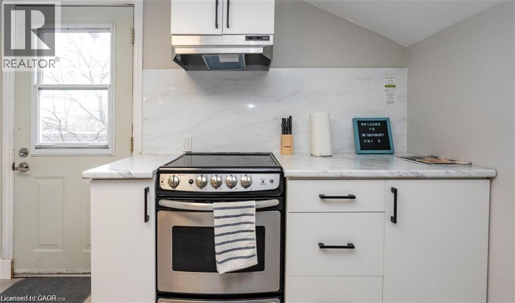 A white kitchen with a stove and oven.