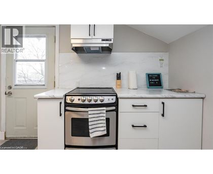 A white kitchen with a stove and oven.