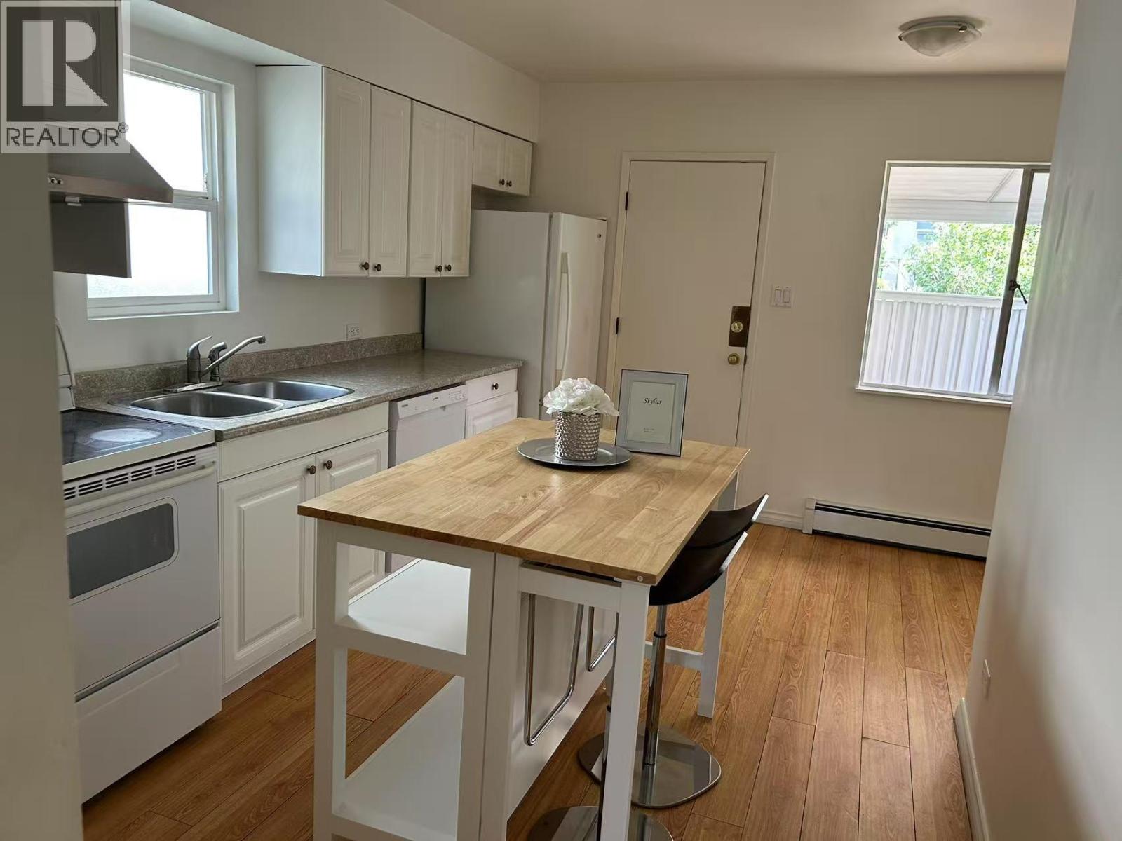 A kitchen with a table and chairs in the middle of it.