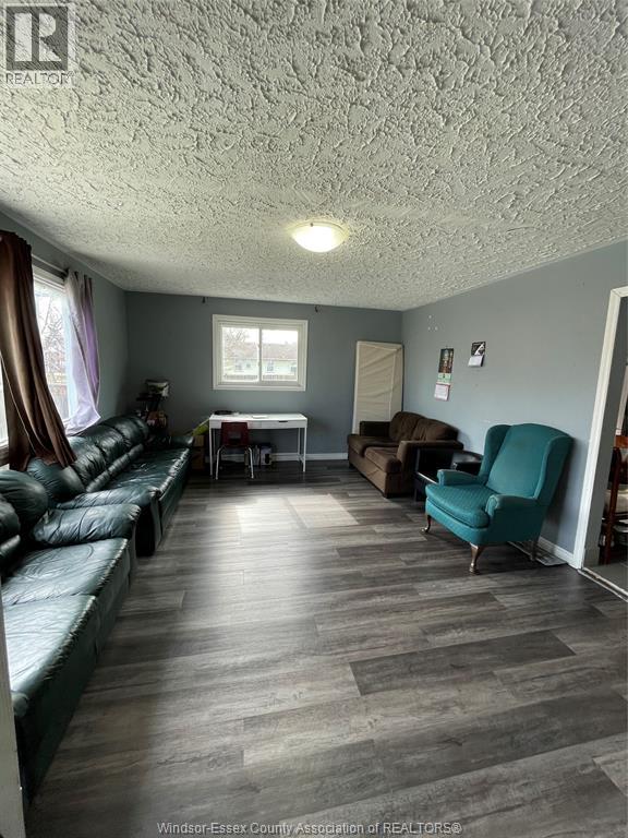 A living room with a couch, chair, and table.