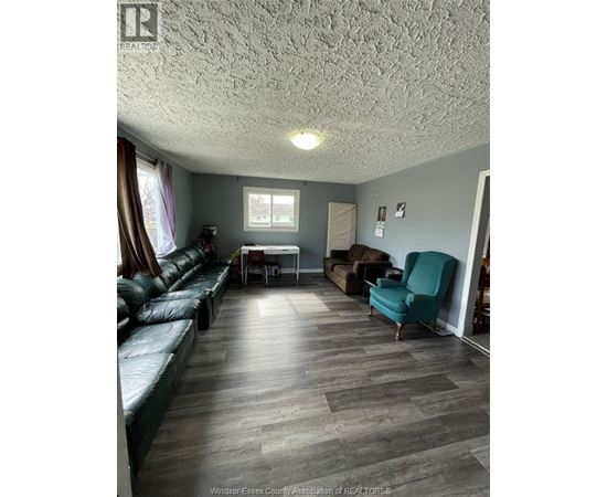 A living room with a couch, chair, and table.