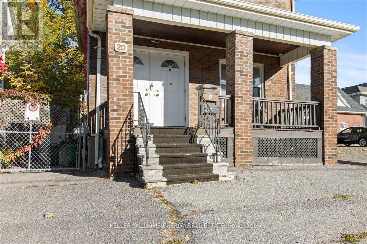 A house with a white door and a number 20 on the wall.