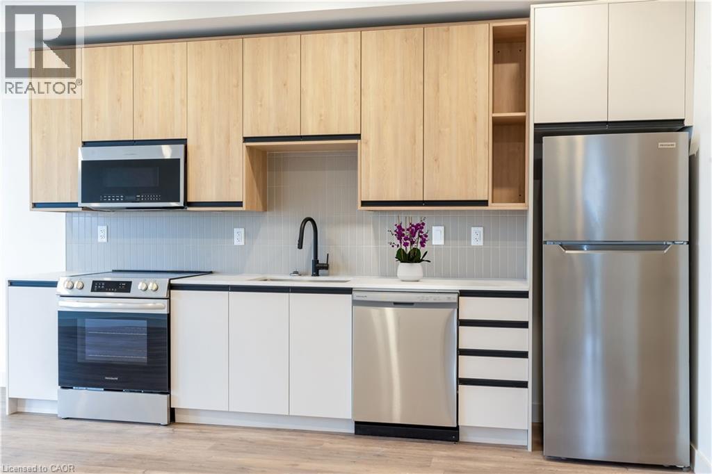 A modern kitchen with wooden cabinets and stainless steel appliances.