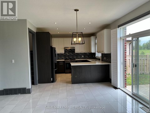A modern kitchen with a large island and a view of the backyard.