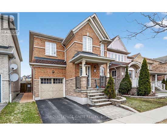 A house with a brick facade and a white garage door is for sale.