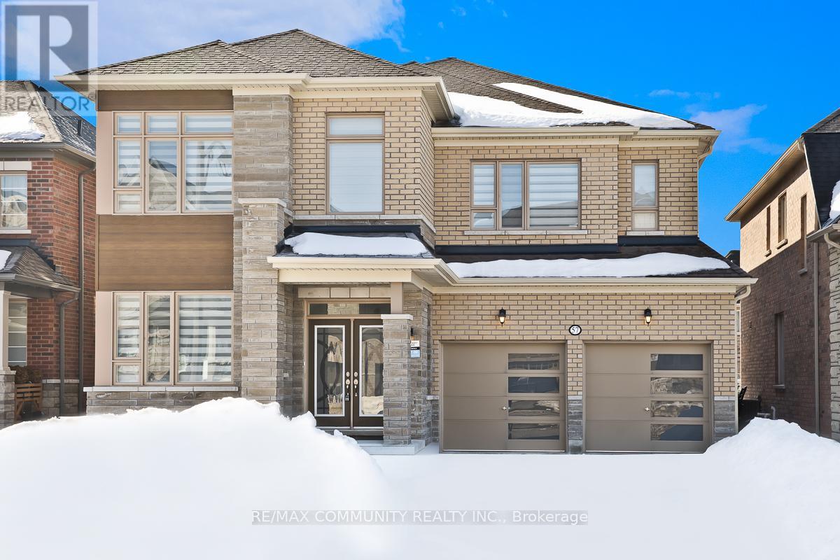 A house with a brown garage door is surrounded by snow.