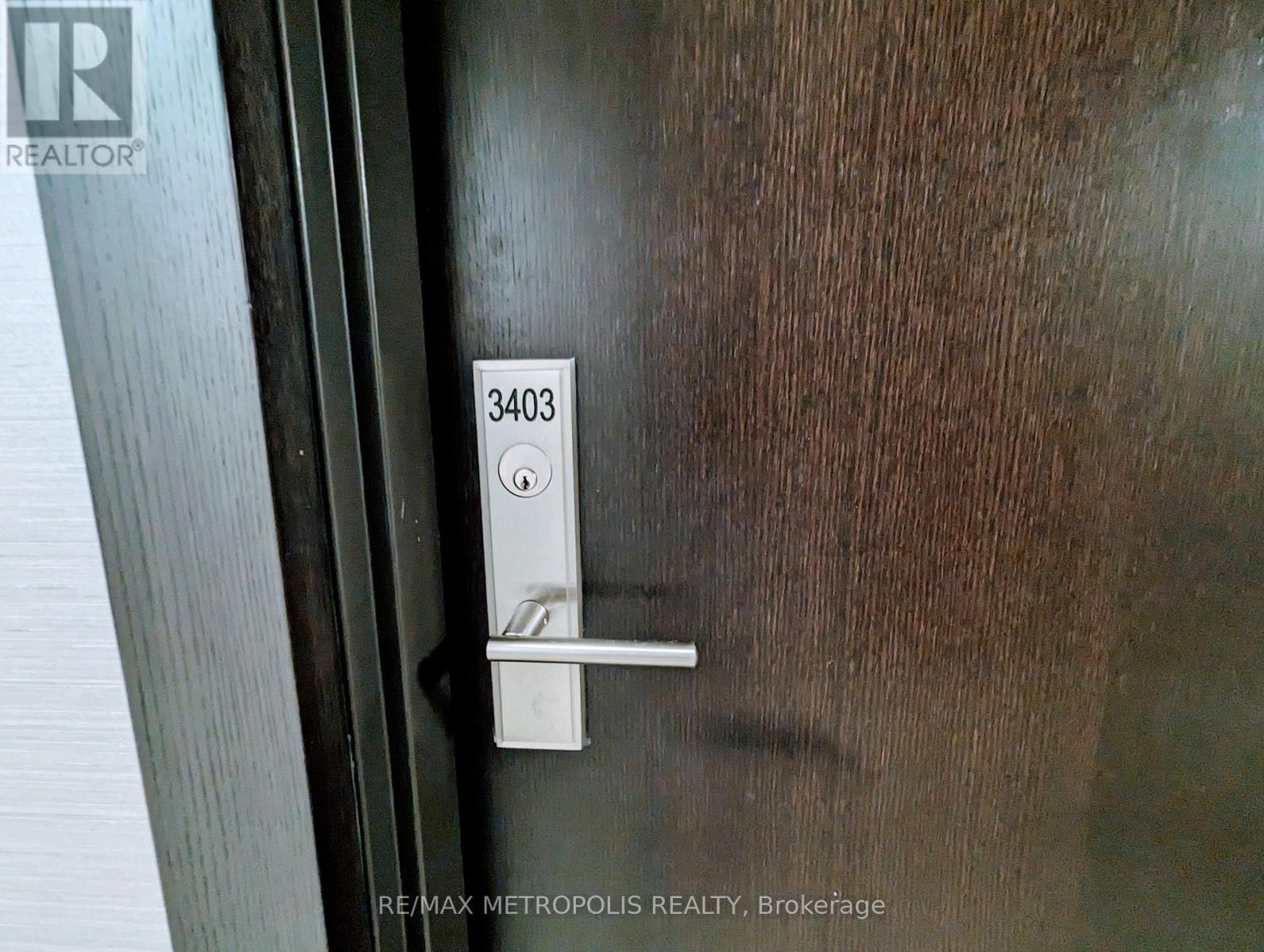A door handle with the number 3403 on it.