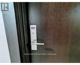 A door handle with the number 3403 on it.