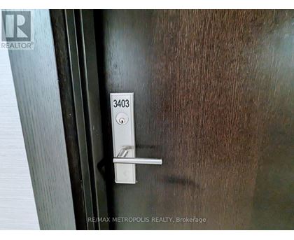 A door handle with the number 3403 on it.