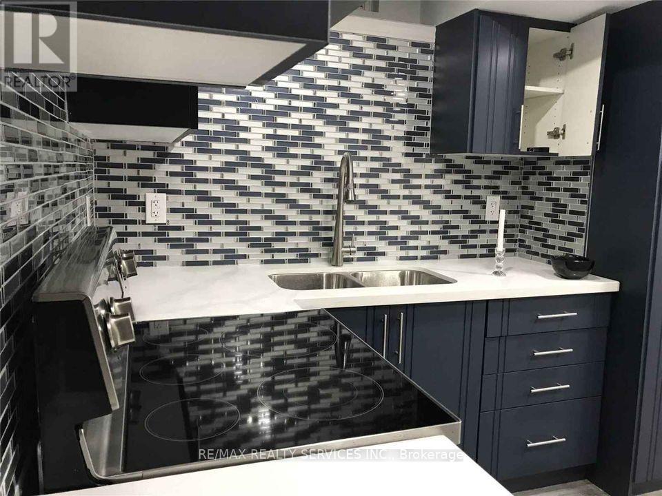 A modern kitchen with a black and white checkered backsplash.