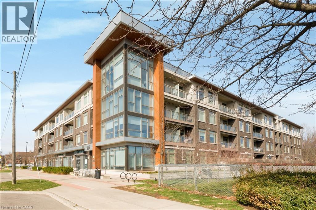 A large apartment building with a glass facade and a brown roof.