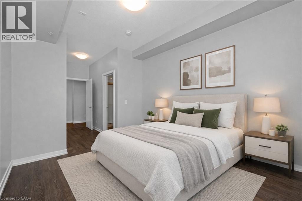 A bedroom with a large bed and two nightstands with lamps.