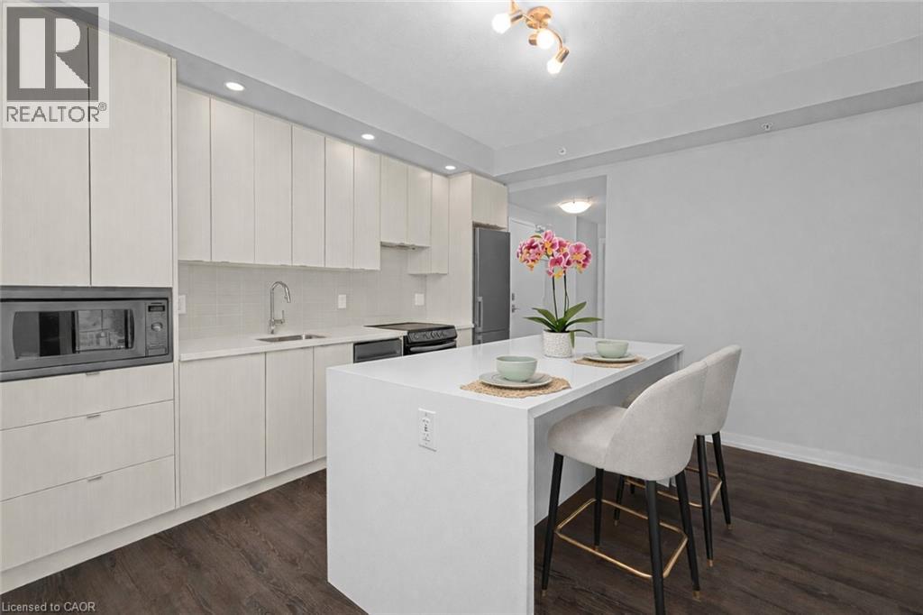 A modern kitchen with white cabinets and a breakfast bar.