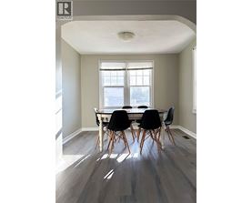 A dining room with a table and chairs.