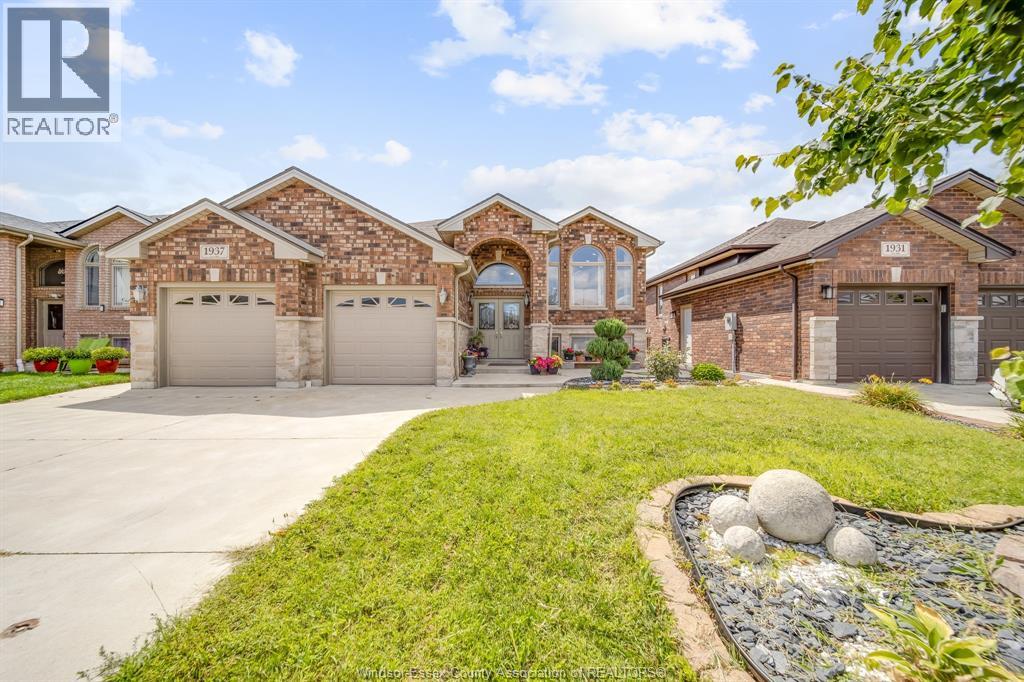 A large, well-maintained house with a driveway and landscaping.