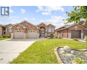 A large, well-maintained house with a driveway and landscaping.