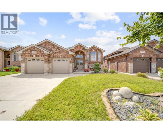 A large, well-maintained house with a driveway and landscaping.