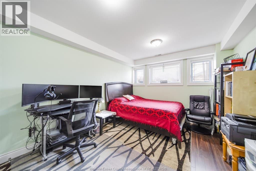 A bedroom with a bed, desk, and chair.