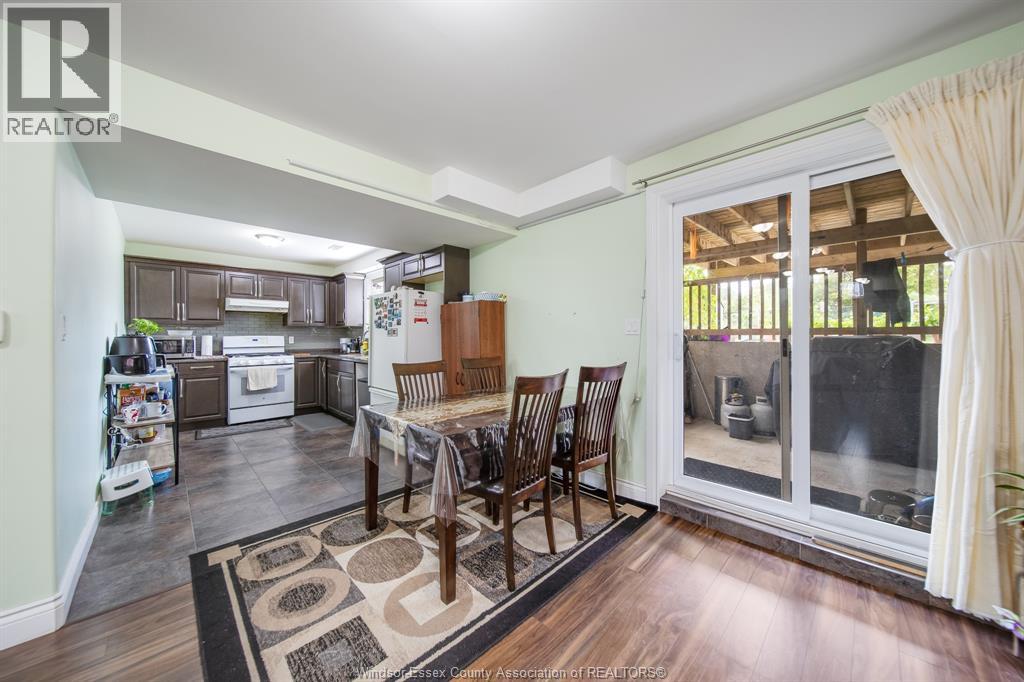 A dining room with a table set for four.