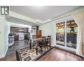 A dining room with a table set for four.