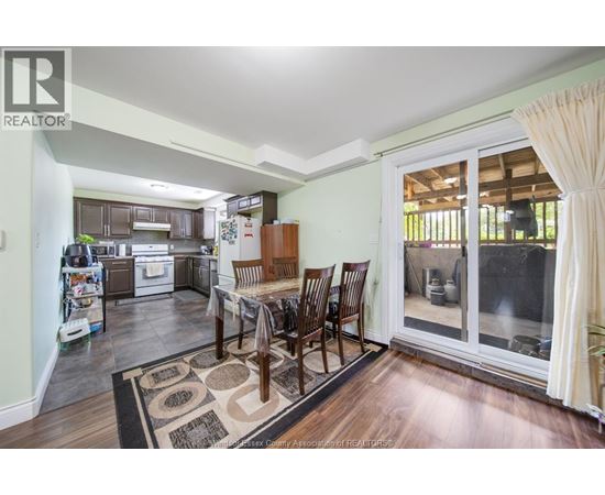 A dining room with a table set for four.