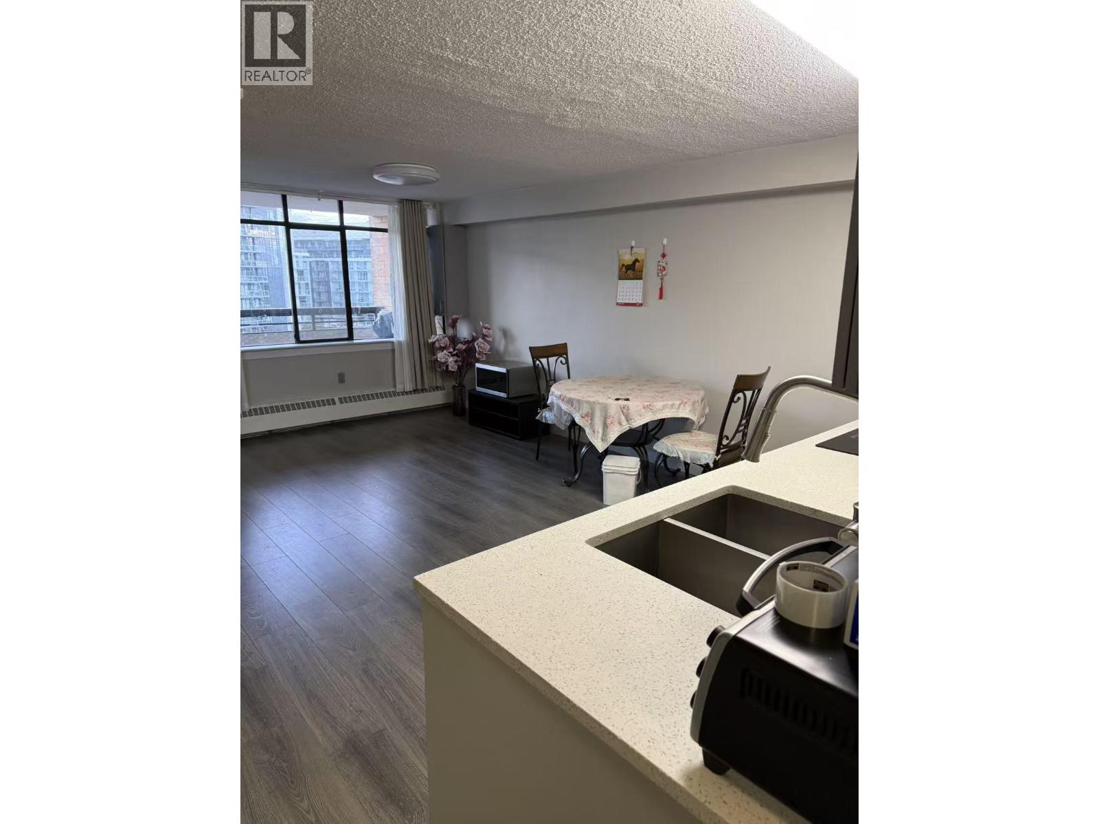 A kitchen with a sink and a window.