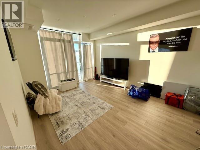 A living room with a flat screen TV mounted on the wall.