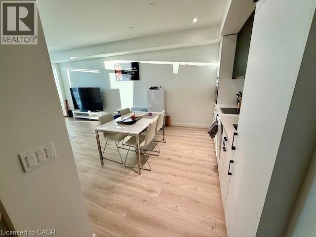 A well-lit kitchen with a dining table and chairs.