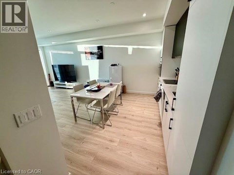 A well-lit kitchen with a dining table and chairs.