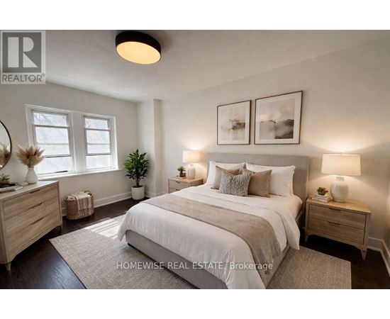 A well-lit bedroom with a large bed, two nightstands, and a plant.