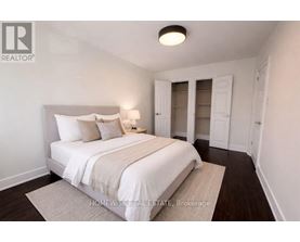 A bedroom with a bed, nightstand, and a lamp.