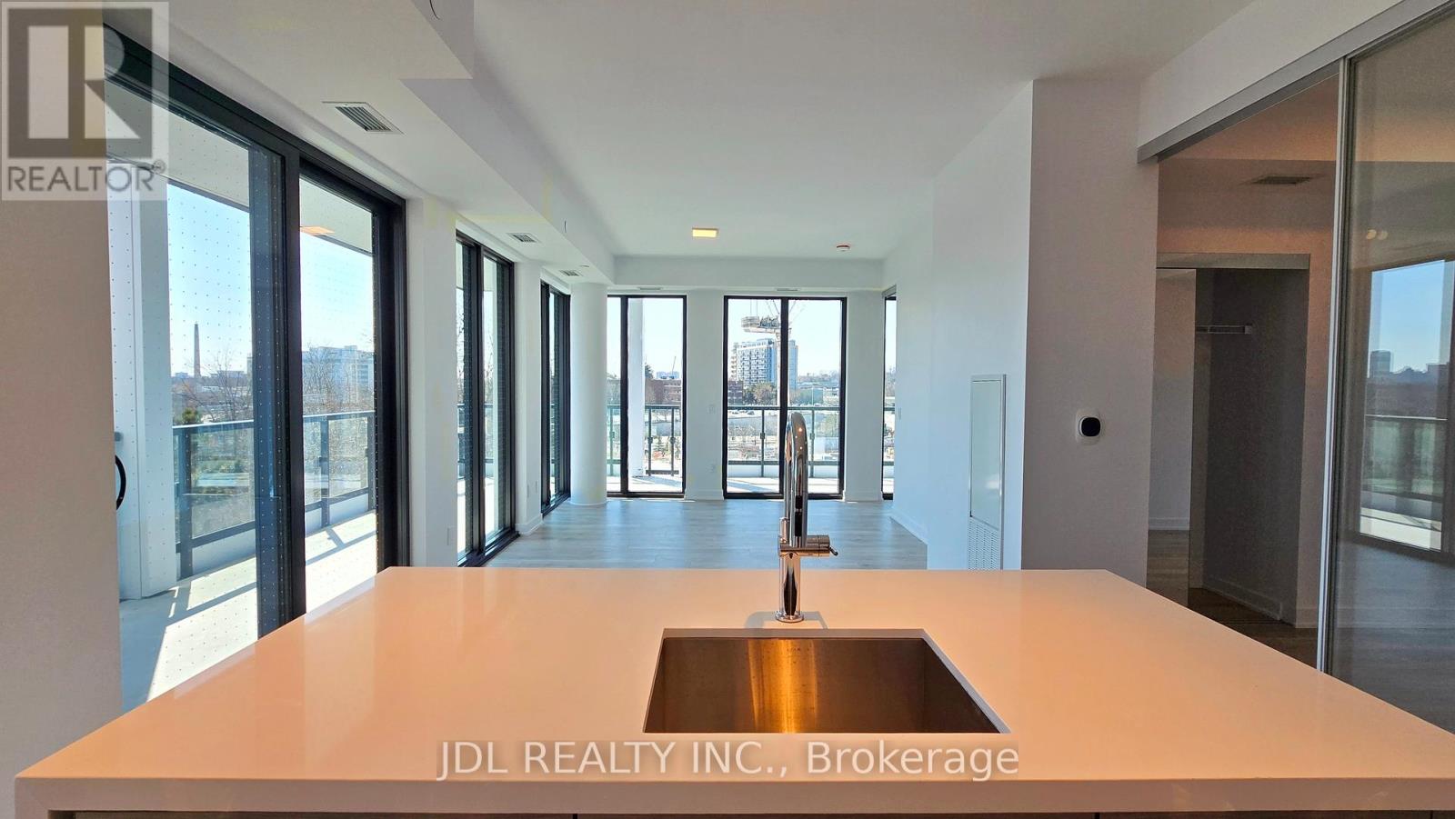A modern kitchen with a sink in the middle of the island.