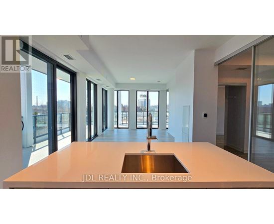 A modern kitchen with a sink in the middle of the island.