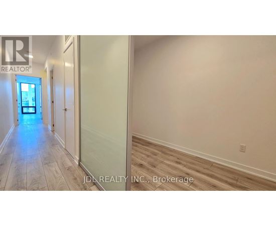 A hallway with a door at the end and a sign that says REALTOR.