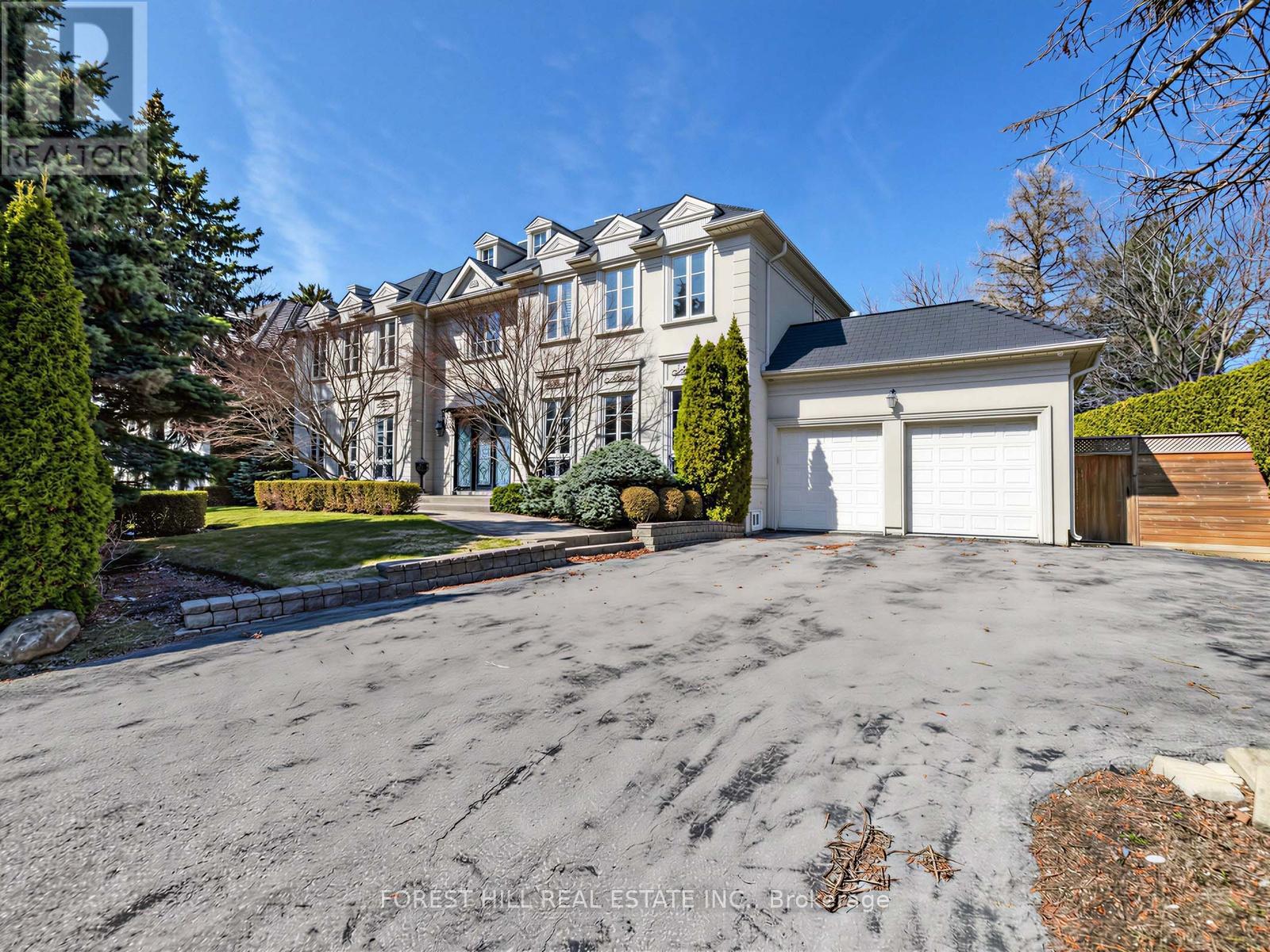A large house with a driveway in front of it.