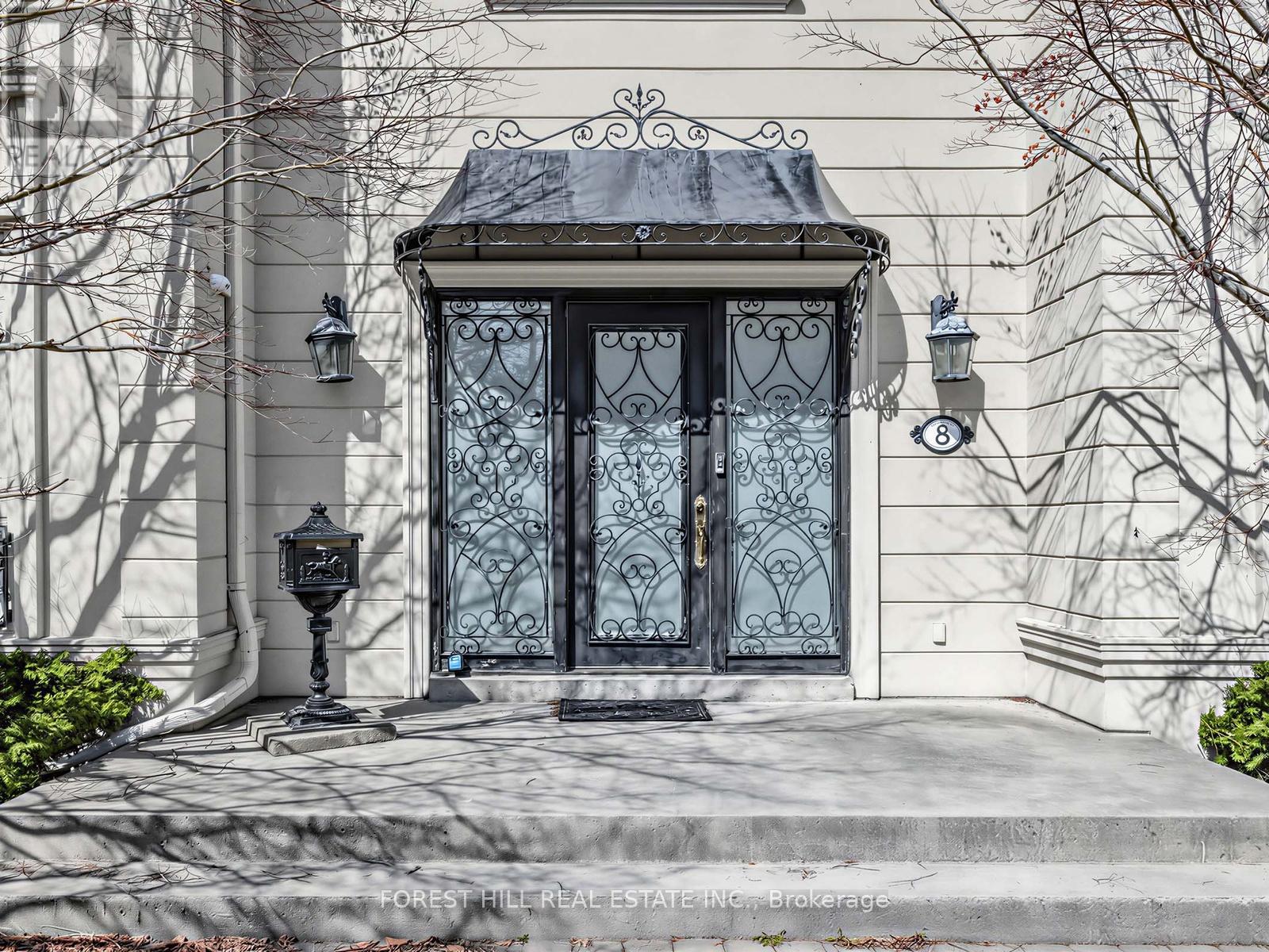 A house with a black door and a black lamp post.