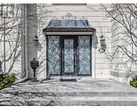 A house with a black door and a black lamp post.